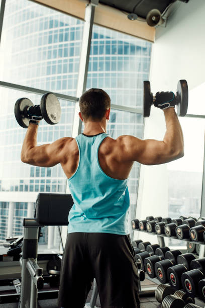 istock Close up of man using dumbbell exercise at gym, Sport concept 2082125411