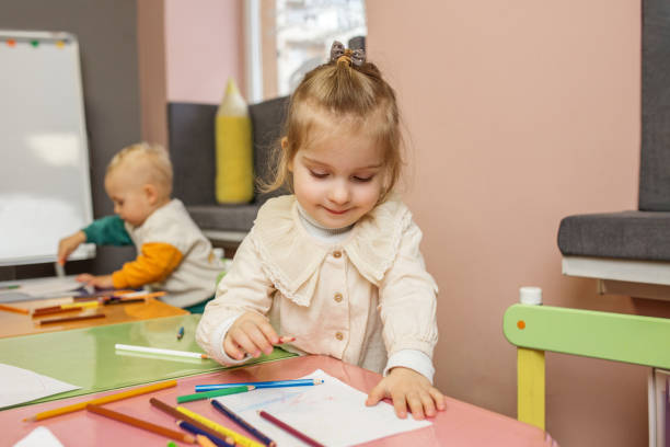istock Smiling Kid Girl Enjoying Drawing Time 2082132911
