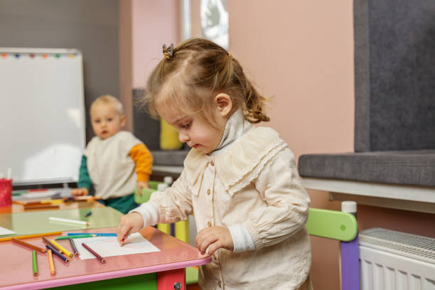 istock Smiling Kid Girl Enjoying Drawing Time. Kindergarten 2082132916