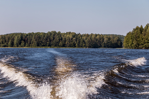 view from a motor boat of the water of Lake Ladoga and rocky islands. Ladoga skerries. Beautiful landscape