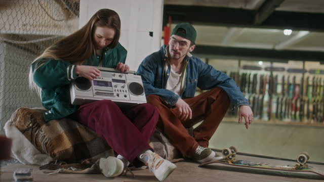 Young Boy and Girl Hanging Out with Boombox at Skatepark