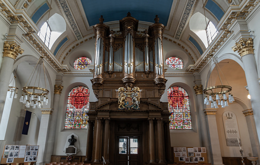 London, UK - Feb 27, 2024 - Interior view St Mary le Bow Church with a Church organ over the exit door in church St.Mary le Bow (Sir Christopher Wren). Space for text, Selective focus.