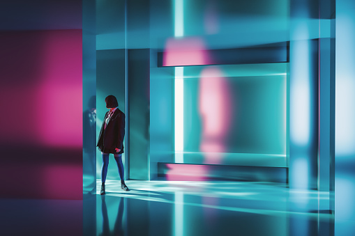 Woman standing in futuristic corridor. 3D generated image.