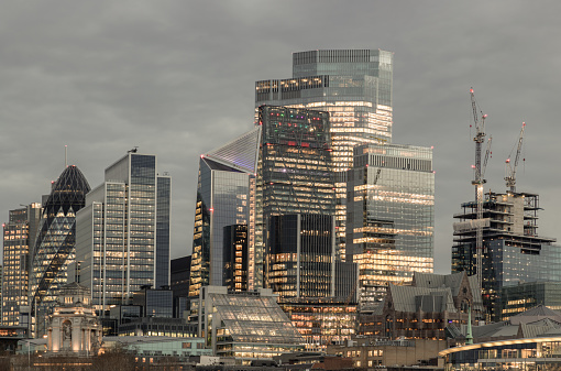 London, UK - Feb 15, 2024 - The illuminated of skyscraper in the business district of London just after sunset. View of architectural modern buildings of the city, Space for text, Selective Focus.