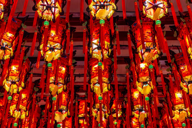 Red and yellow lanterns hang from the ceiling of the Tianhou Temple in the Ximen district of Taipei