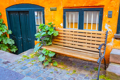 Copenhagen home facade in Christianshavn with public bench and green door