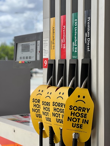 Brisbane - Dec 12  2023:Sorry hose not in use signs on different octanes in filling station fuel pumps.Several countries and car manufacturers have plans to go all electric by the end of the decade.