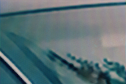 A magnified look at the pixels of an LCD screen, dark green grey white black creepy scary unnerving digital tech background monitor display texture macro detail front view, extreme closeup, nobody