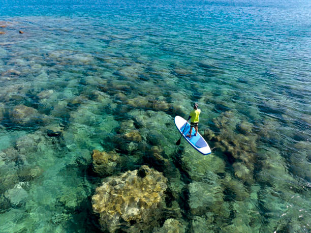 istock Aerial view of man floating on a stand up paddle 2082302268