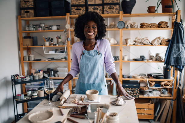 istock Interracial craftswoman standing at pottery studio and having wine. 2082305094