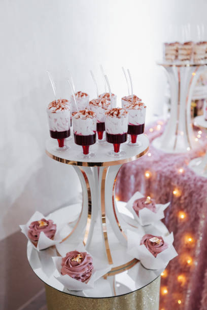 istock Festive dessert table with sweets. Wedding candy bar, various cakes, chocolates on stands. 2082306323