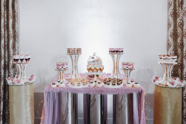 istock Festive dessert table with sweets. Wedding candy bar, various cakes, chocolates on stands. 2082306331
