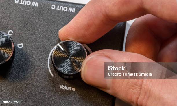 Anonymous Drive Control Anonymous Man Fingers Finely Tuning A Volume Knob On A Sleek Audio ...