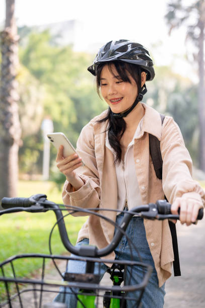 istock A happy young Asian female college student is using her smartphone while on her way to campus. 2082380520