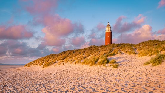 Texell lighthouse during sunset Netherlands Dutch Island Texel in summer with sand dunes at the Wadden Island in the evening