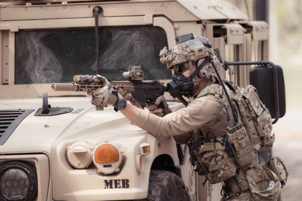 istock Soldiers in camouflage uniforms hold weapons ready to fire 2082441124