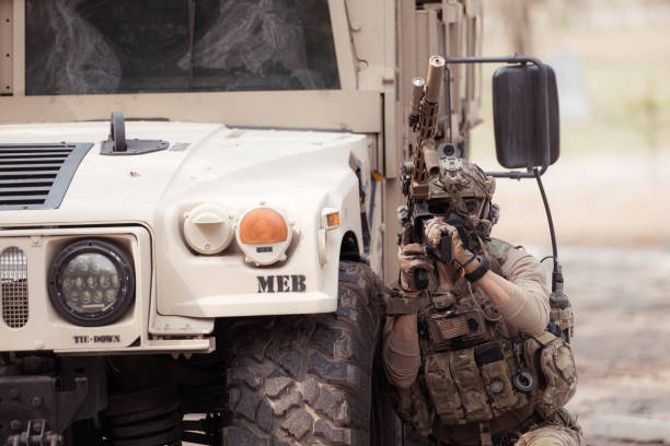 istock Soldiers in camouflage uniforms hold weapons ready to fire 2082441635