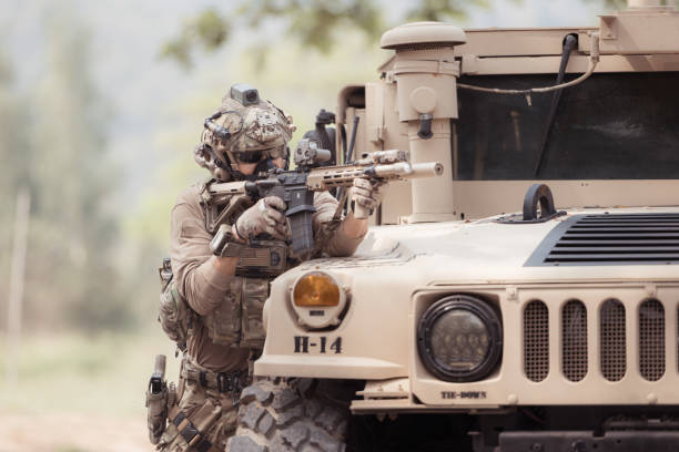 istock Soldiers in camouflage uniforms hold weapons ready to fire 2082441644