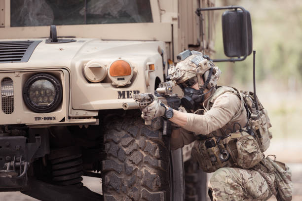 istock Soldiers in camouflage uniforms hold weapons ready to fire 2082441651