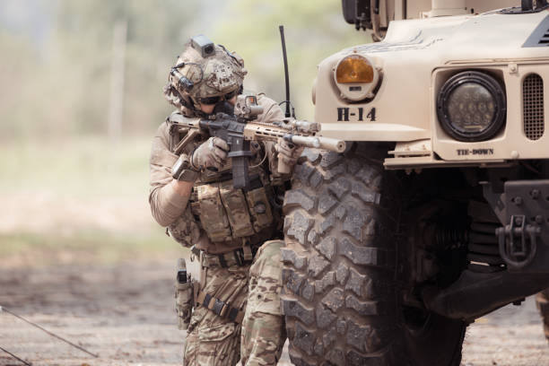istock Soldiers in camouflage uniforms hold weapons ready to fire 2082441666