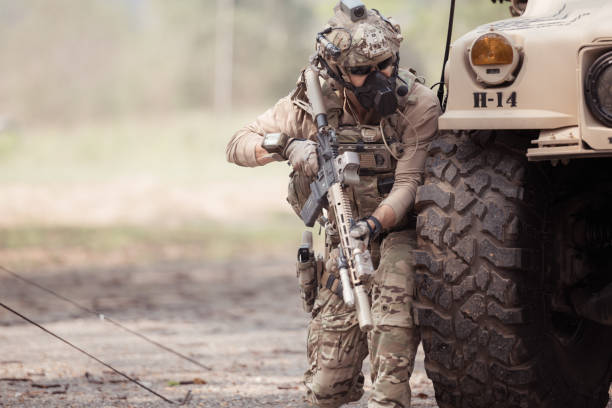istock Soldiers in camouflage uniforms hold weapons ready to fire 2082442158
