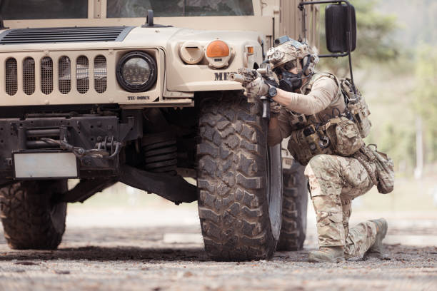 istock Soldiers in camouflage uniforms hold weapons ready to fire 2082442159