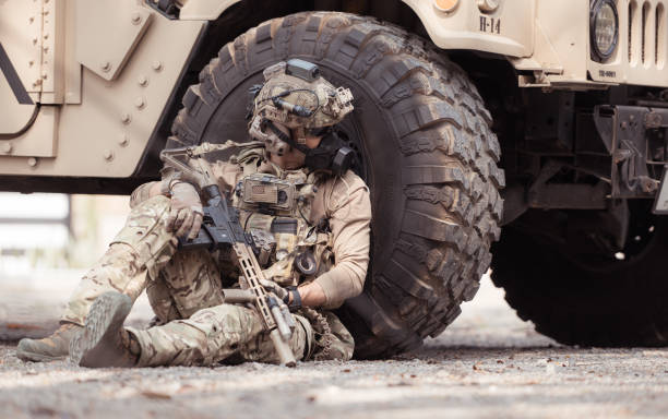 istock Soldiers in camouflage uniforms hold weapons ready to fire 2082442166