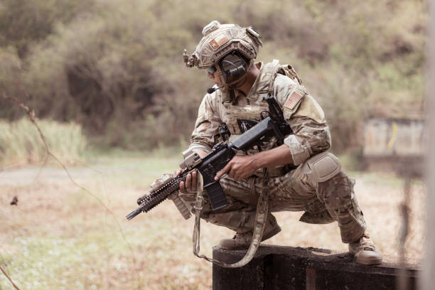istock Soldiers in camouflage military uniforms carrying weapons 2082446441