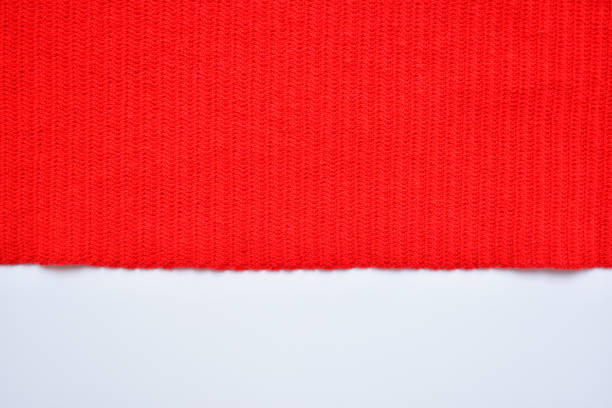 istock red wool knitted yarn texture, woolen fabric on white background 2082459891