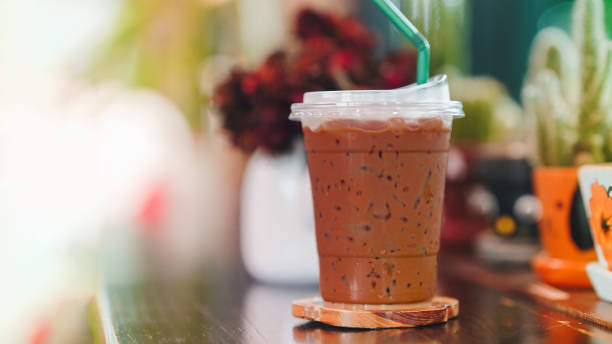 istock Iced coffee in a plastic glass on a wooden table. Copy space. 2082483512