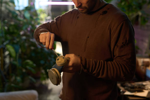 istock Man Repairing Old Air-purifying Respirator 2082512337