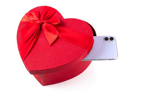Smartphone and gift box in the form of a human heart symbol on a white background