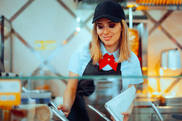 istock Woman Working in a Fast-Food Restaurant Preparing a Snack 2082569295