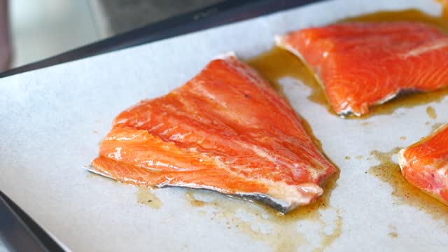 putting oil on salmon fillet .