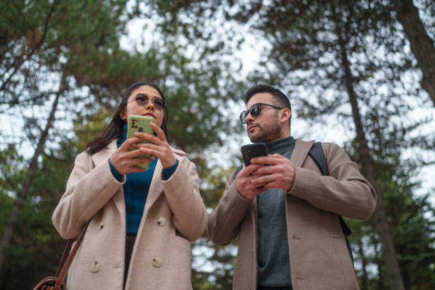 istock Business people walking in a natural park, using mobile phone. 2082671280