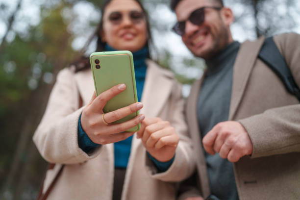 istock Business people walking in a natural park, using mobile phone. 2082673369