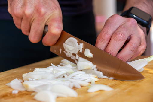 Culinary art: Chopping onion for a creamy rice.