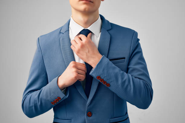 istock man in suit straightens his tie cropped view 2082779961