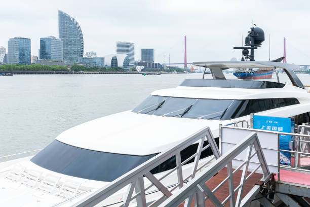 Shanghai, China - June 3rd 2022: The landmark platform of the modern commercial city and the urban yacht wharf - the prosperous scene with the background of Shanghai Global Financial Center.