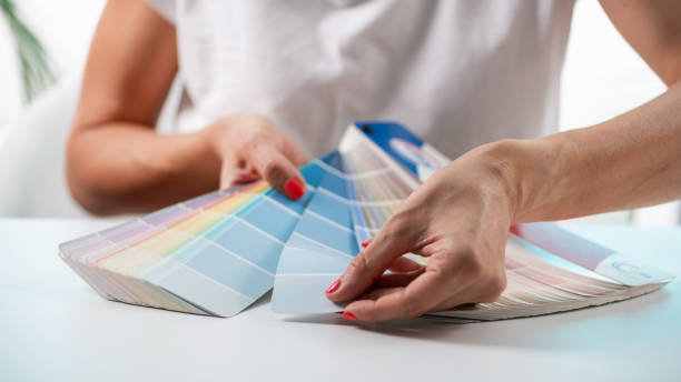 istock A designer meticulously selects colors from a palette, exploring creative options for their project 2082826176