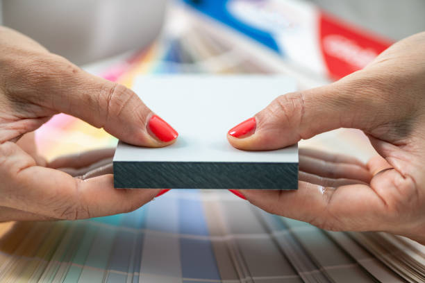 istock A designer holds up various compact board sample, demonstrating options for interior design projects 2082827759