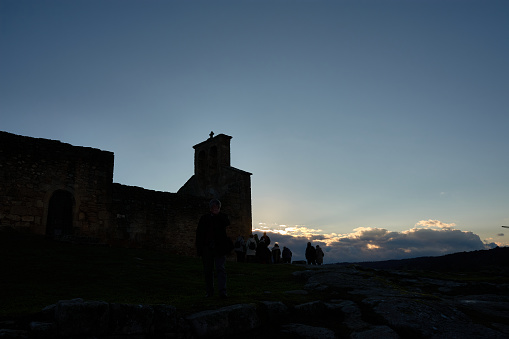 Silhouette of the Church of Our Lady of the Castle with silhouettes of people in Castelo Mendo Portugal