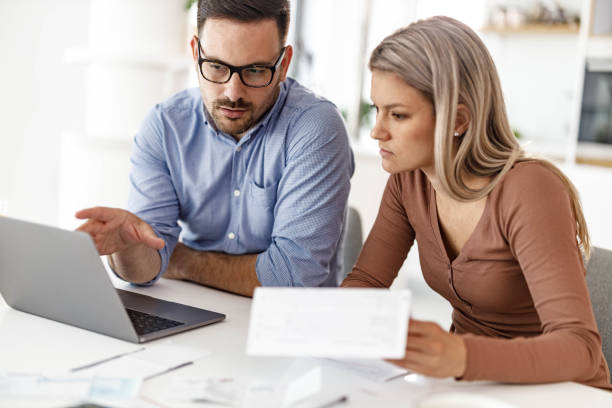 istock Young couple paying their bills over laptop at home. 2082871549