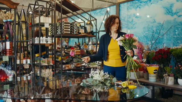 Confident Mature Female Owner Making a Beautiful Floral Bouquet For Sale at Flower Shop