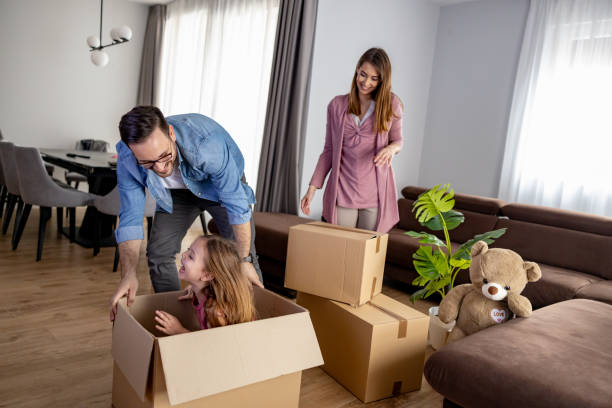 istock Young smiling happy family unpacking during move 2082893233