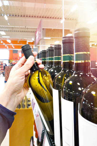 istock Bottle of white wine on hand 2082902647