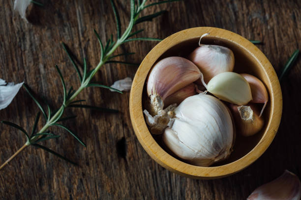 garlic on wooden background stock photo