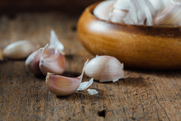 garlic on wooden background stock photo