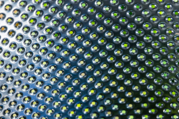 Washing machine drum structure, stainless steel with small holes, abstract industrial background texture