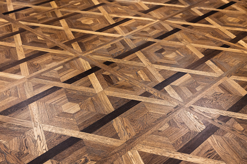 Luxury vintage parquet made of various wood types with geometric pattern. Background photo